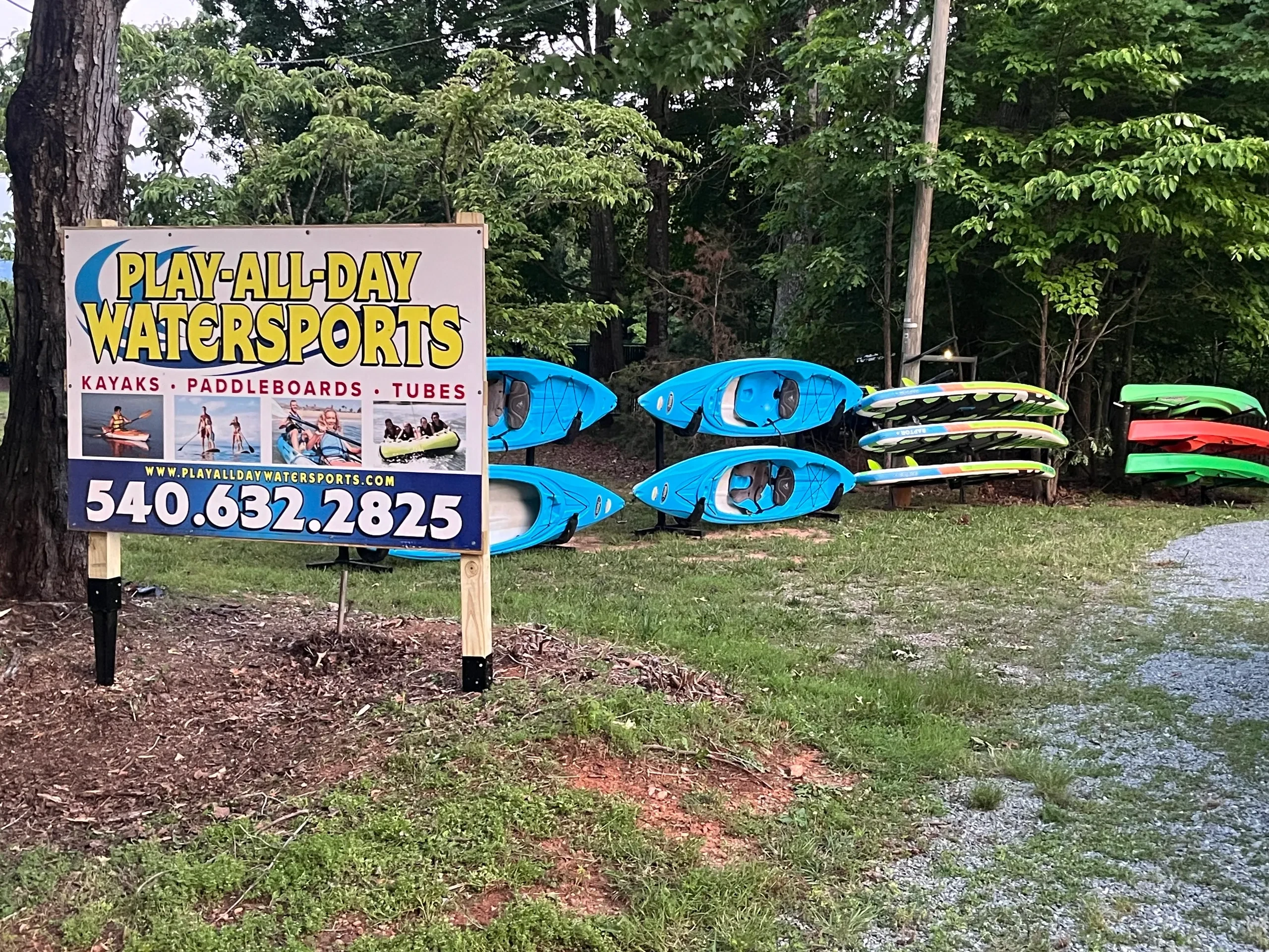 Play-All-Day Watersports sign and kayak fleet