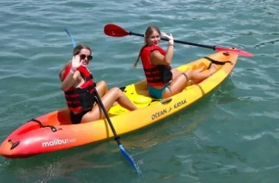 Two girls in a tandem kayak